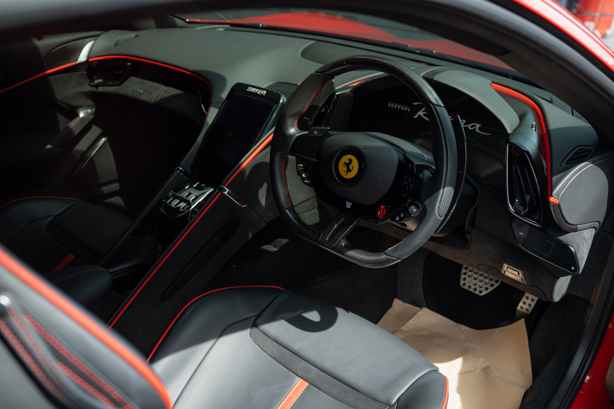Ferrari Roma cabin — carbon wheel and Roma script