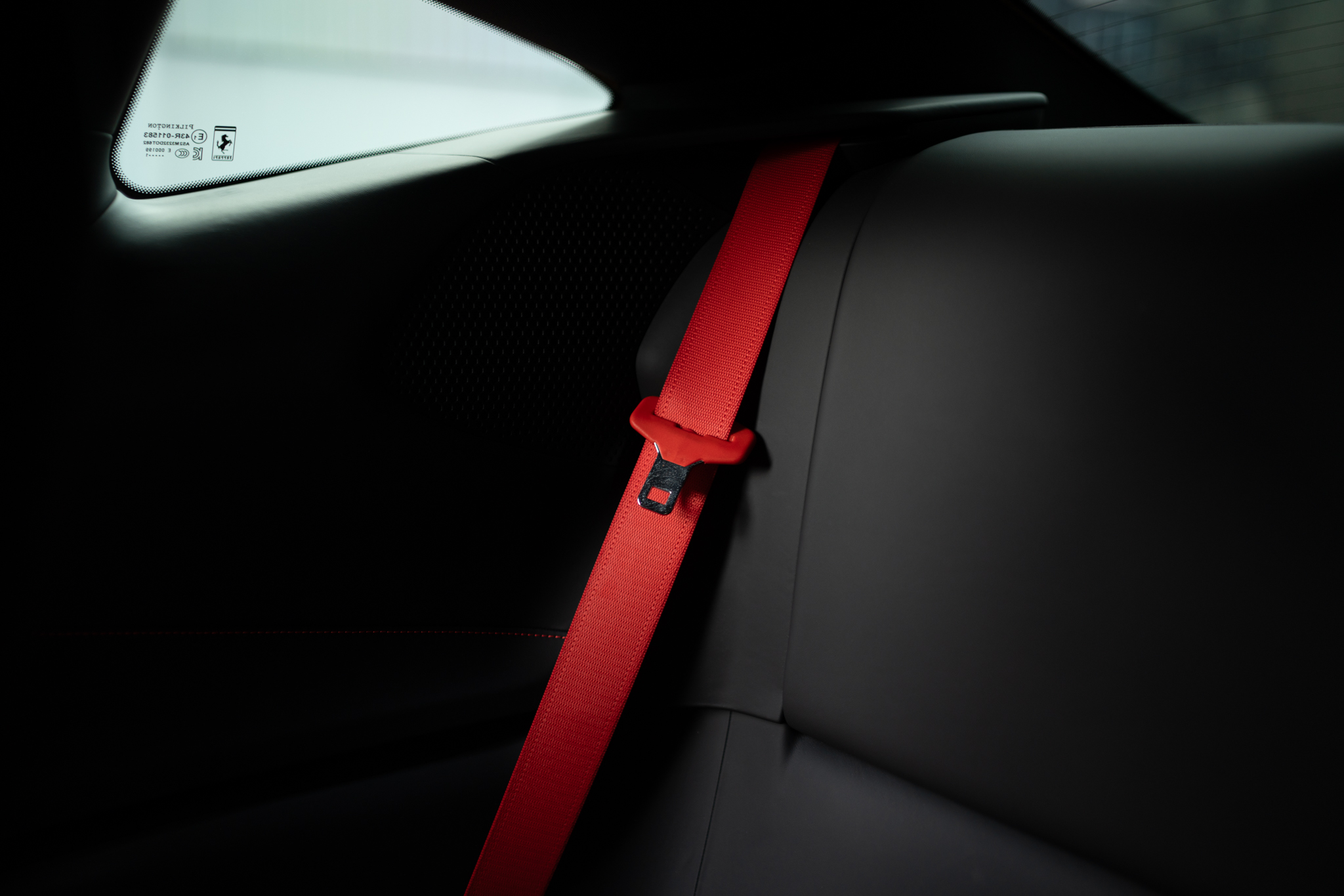Ferrari Roma cabin — red seatbelt over black