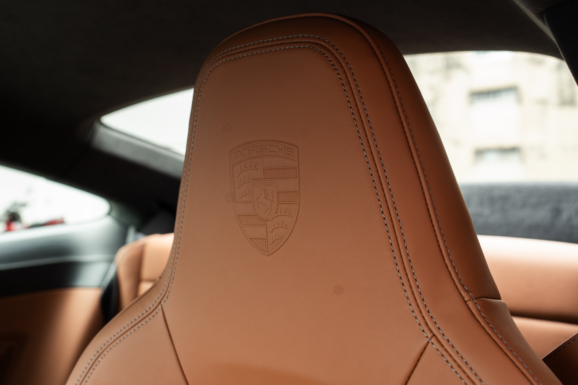 Porsche 911 GT3 Touring — cognac leather seat with embossed crest