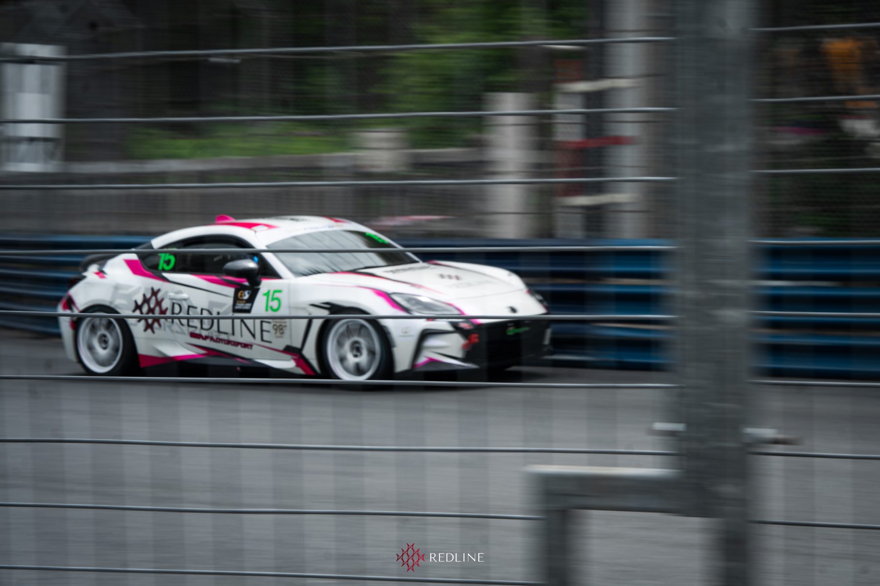 Redline GR86 #15 at speed behind the barriers at Bangsaen