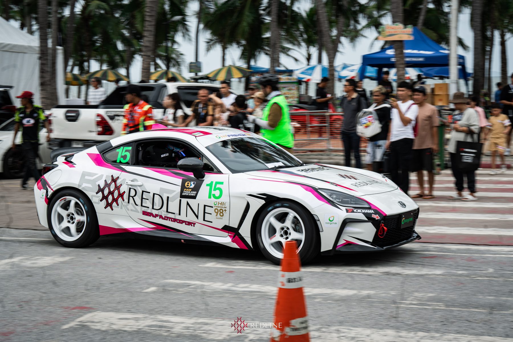 Redline GR86 #15 on the Bangsaen street circuit with spectators